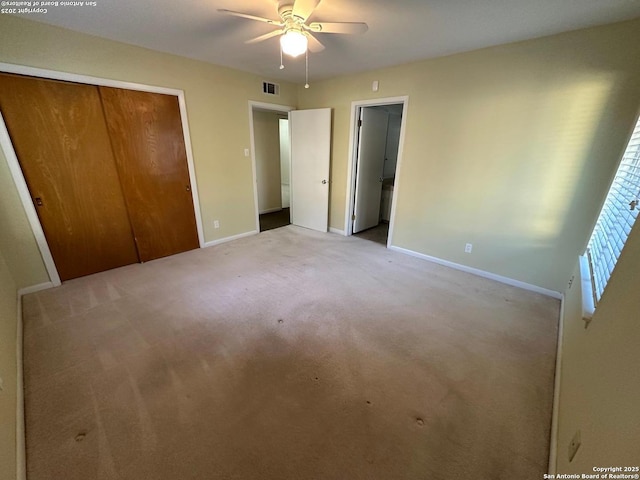 unfurnished bedroom featuring carpet floors, a closet, visible vents, and baseboards