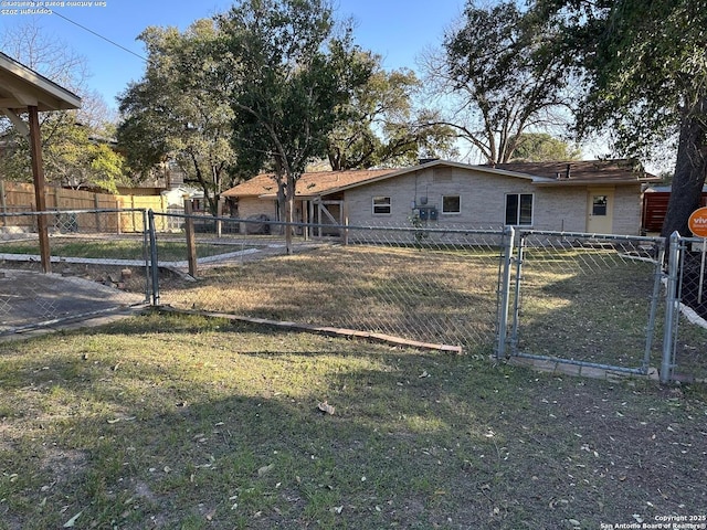 exterior space featuring a front yard, a gate, and fence