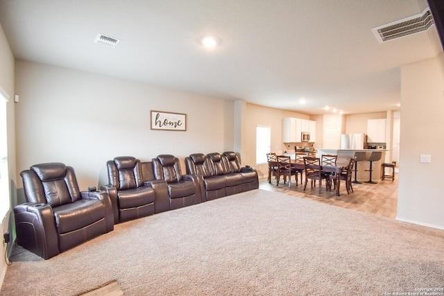 cinema with recessed lighting, visible vents, baseboards, and light colored carpet