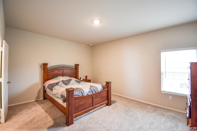 bedroom featuring carpet floors and baseboards