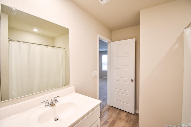 bathroom with wood finished floors and vanity