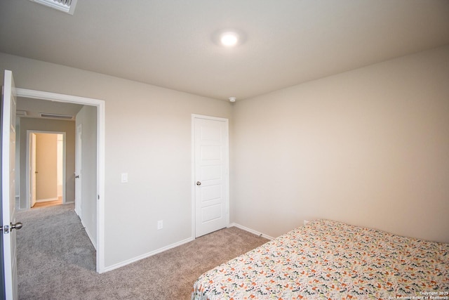 unfurnished bedroom featuring light carpet and baseboards