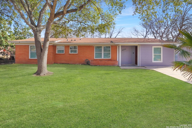 single story home featuring brick siding and a front yard