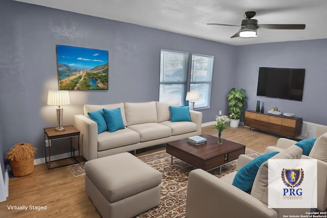 living area featuring ceiling fan, baseboards, and wood finished floors