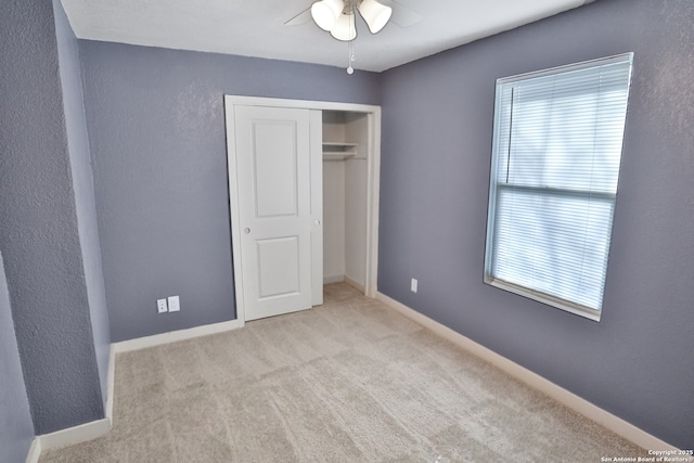 unfurnished bedroom with a ceiling fan, a closet, baseboards, and carpet flooring