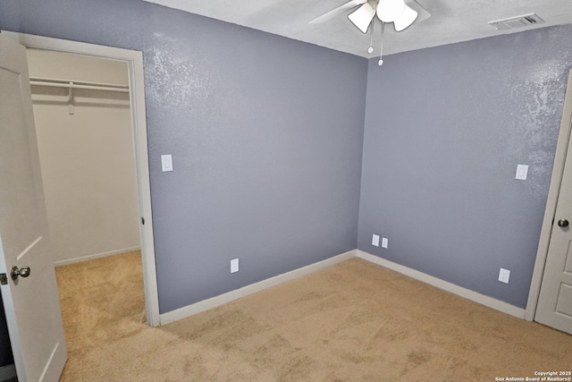 unfurnished bedroom featuring a ceiling fan, carpet, visible vents, and baseboards