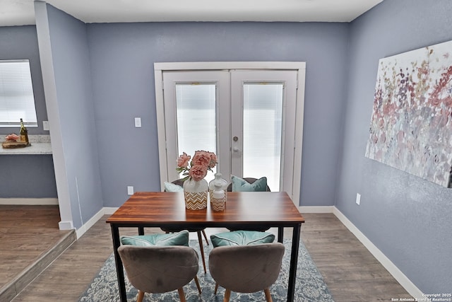 dining space with baseboards, dark wood-style flooring, and french doors