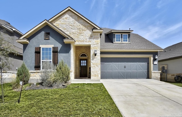 view of front of home featuring driveway, stone siding, an attached garage, and a front lawn