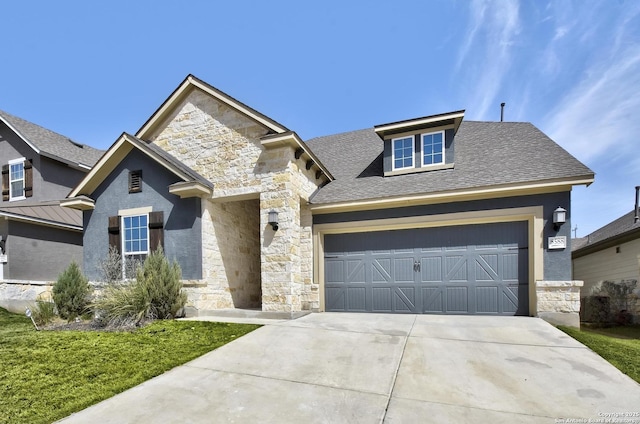 view of front facade featuring a shingled roof, stone siding, driveway, and an attached garage