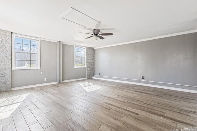 spare room with a ceiling fan, baseboards, and wood finished floors