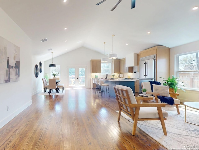 living area featuring light wood-style flooring, recessed lighting, visible vents, baseboards, and french doors