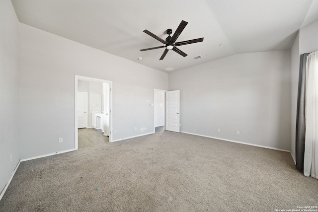 unfurnished bedroom with carpet, lofted ceiling, visible vents, ensuite bath, and baseboards