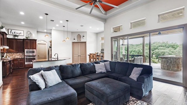 living room with dark wood finished floors, recessed lighting, visible vents, a high ceiling, and a ceiling fan