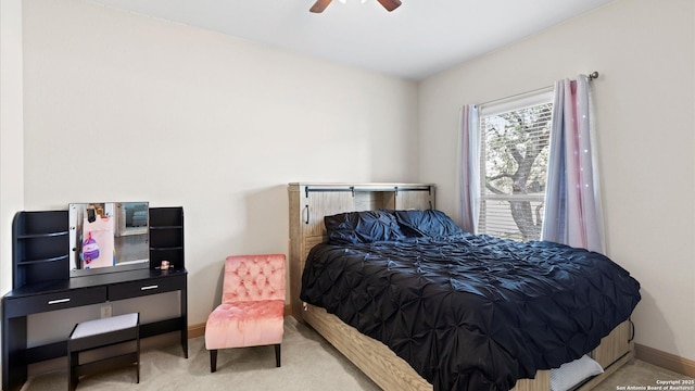 bedroom with carpet floors, a ceiling fan, and baseboards