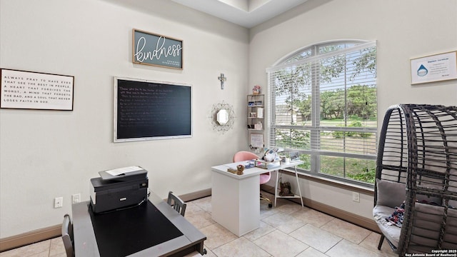 office with light tile patterned floors, a wealth of natural light, and baseboards