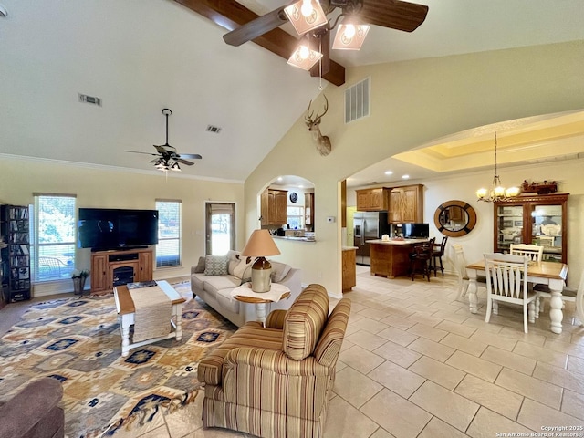 living room featuring arched walkways, beam ceiling, visible vents, and ceiling fan with notable chandelier