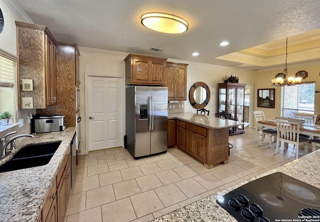 kitchen with brown cabinets, visible vents, a sink, a peninsula, and stainless steel fridge with ice dispenser