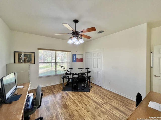 office space with ceiling fan, wood finished floors, visible vents, and baseboards