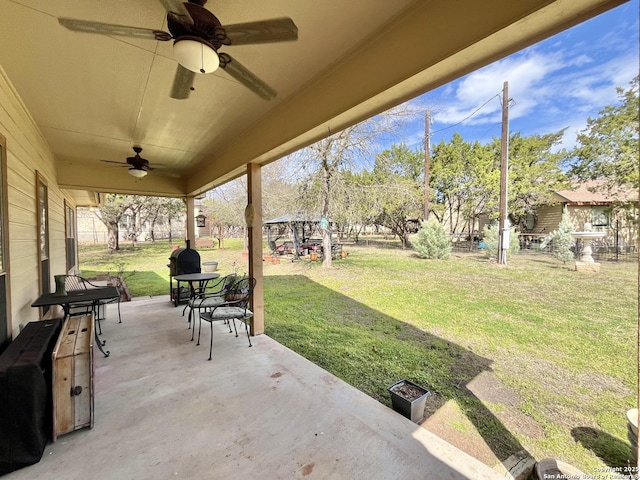 view of patio / terrace featuring ceiling fan and fence