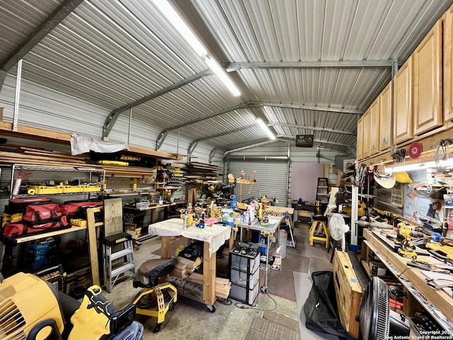 garage featuring a workshop area, metal wall, and a garage door opener