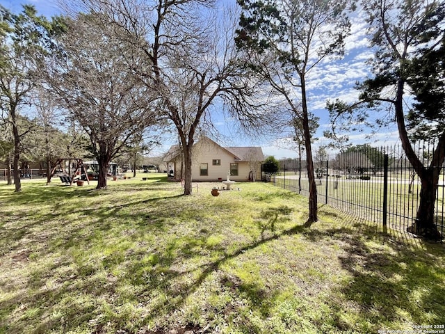 view of yard featuring a playground and fence