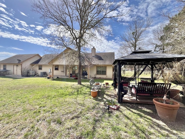 view of yard featuring central air condition unit and a gazebo