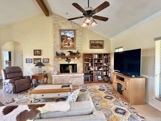 living room with arched walkways, ceiling fan, a fireplace, high vaulted ceiling, and beam ceiling