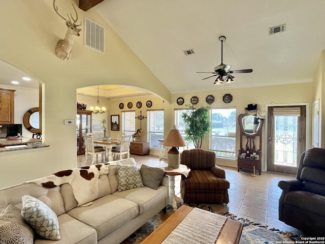 living area featuring arched walkways, visible vents, and light tile patterned floors