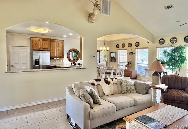 living room with lofted ceiling, visible vents, arched walkways, and ornamental molding