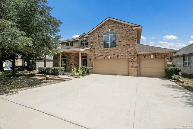 traditional-style home with concrete driveway and brick siding