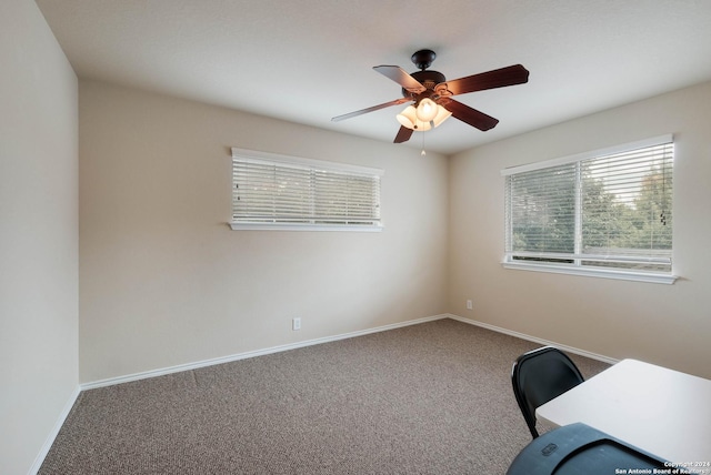 unfurnished office featuring ceiling fan, baseboards, and carpet flooring