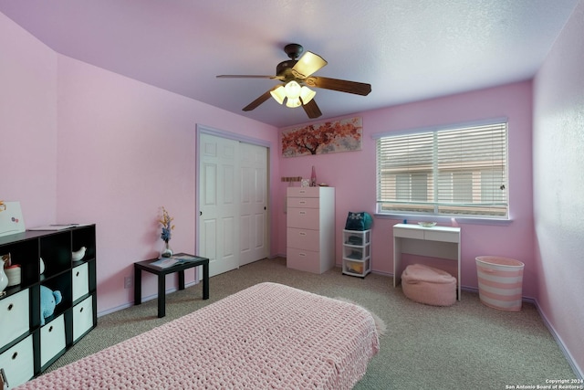 bedroom featuring carpet floors, a closet, baseboards, and a ceiling fan