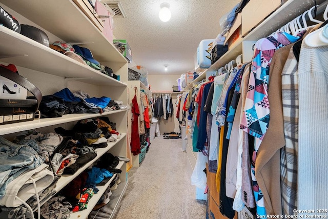 walk in closet featuring carpet and visible vents