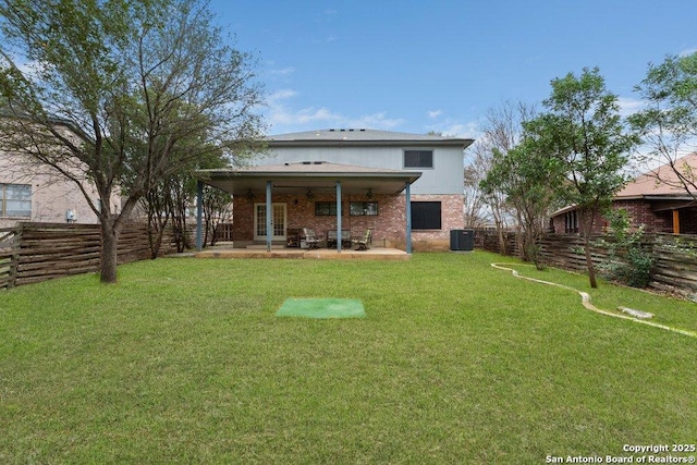 rear view of property with central AC, a patio, a fenced backyard, and a lawn