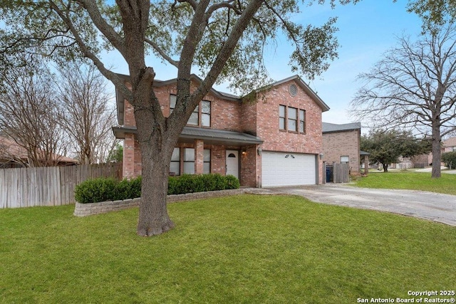 traditional home with an attached garage, a front yard, fence, and brick siding