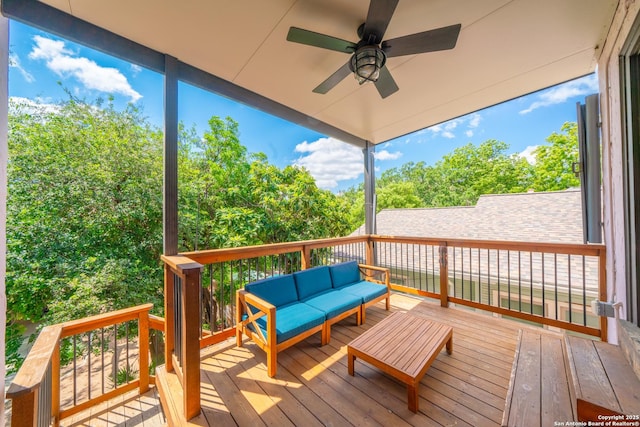 deck with ceiling fan and an outdoor living space