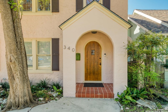 doorway to property with stucco siding