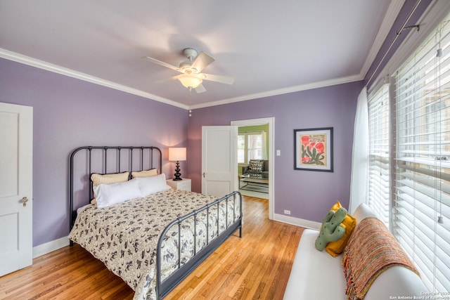 bedroom featuring ornamental molding, a ceiling fan, baseboards, and wood finished floors