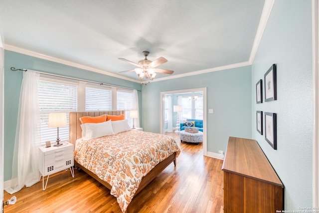 bedroom featuring light wood finished floors, baseboards, ornamental molding, and ceiling fan