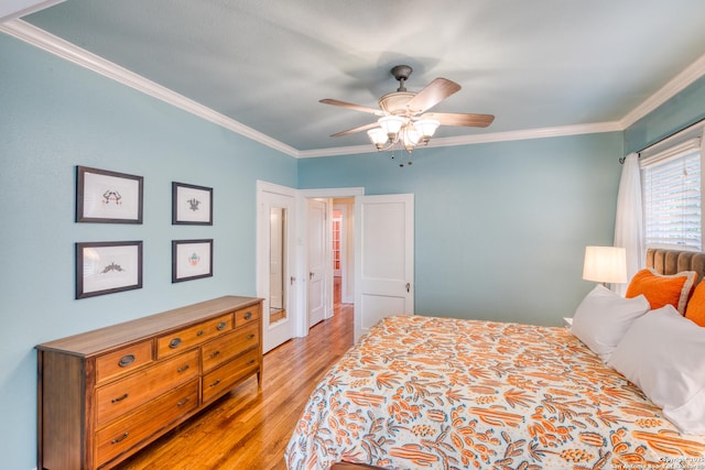 bedroom with a ceiling fan, light wood-type flooring, and crown molding