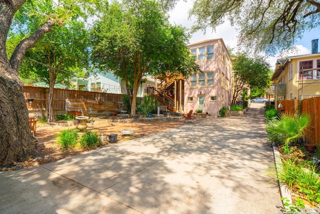 view of front of house with stairway and fence