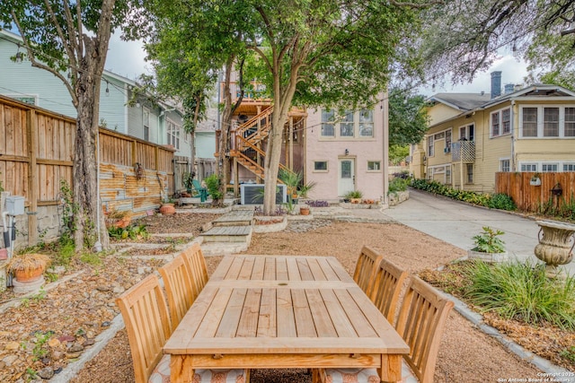 back of house featuring fence private yard, outdoor dining space, a residential view, and a patio