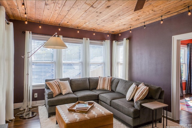 living room with rail lighting, wood ceiling, and wood finished floors