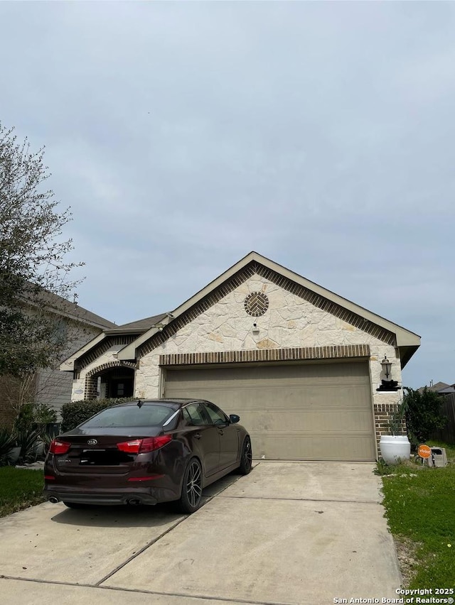 view of front of property with driveway, an attached garage, and brick siding