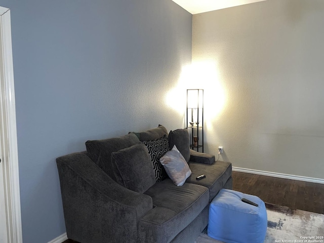 living room featuring baseboards and wood finished floors