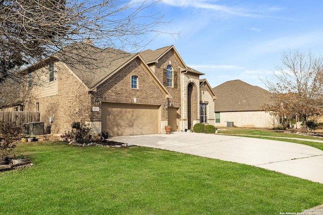 view of front of property with brick siding, concrete driveway, fence, a garage, and a front lawn