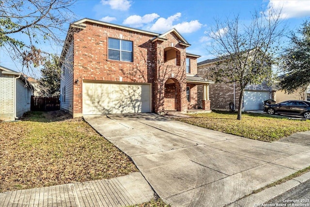 traditional-style house featuring a garage, brick siding, concrete driveway, fence, and a front yard