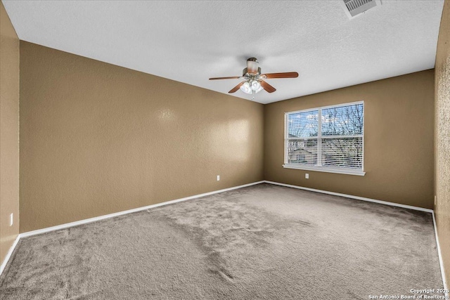 carpeted spare room featuring baseboards, visible vents, a ceiling fan, a textured wall, and a textured ceiling