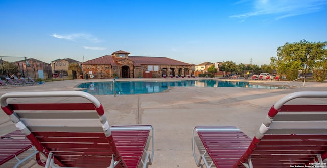 community pool featuring a patio and fence