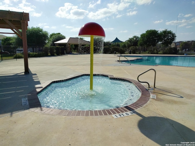 community pool featuring a gazebo, a patio area, fence, and a hot tub